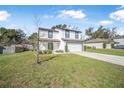 Charming two-story home featuring a manicured lawn and a convenient two-car garage at 348 Southern Winds Blvd, Deland, FL 32720