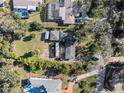 Aerial view of a property showcasing the roof, backyard, and surrounding landscaping at 445 John Anderson Dr, Ormond Beach, FL 32176