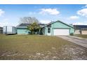 Attractive single-story home boasting solar panels, a two-car garage, and a lush front lawn at 934 Wilmington Dr, Deltona, FL 32725