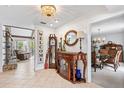 Bright foyer with a chandelier, decorative furniture, and an open view to the dining area at 13 Twin River Dr, Ormond Beach, FL 32174