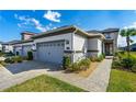 Home with a gray-tone garage door, manicured landscaping, and a welcoming walkway at 131 Longridge Ln, Ormond Beach, FL 32174