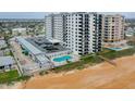 View of Regency Plaza from the beach with pool, parking and walkover at 1415 Ocean Shore Blvd # L1, Ormond Beach, FL 32176