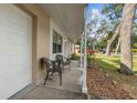 Inviting front porch featuring seating, offering a cozy outdoor space next to the garage at 354 Fir St, Ormond Beach, FL 32174