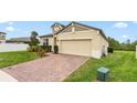 Inviting single-Gathering home featuring a brick-paver driveway leading to a spacious two-car garage at 806 Armenia Ct, New Smyrna Beach, FL 32168