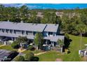 View of condo featuring mature trees and landscaping, creating a serene outdoor environment at 150 Limewood Pl # F, Ormond Beach, FL 32174