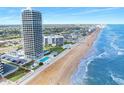 Scenic aerial view of Aliki Tower on the beach with ocean views and community pool at 3000 N Atlantic Ave # 11, Daytona Beach, FL 32118