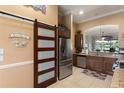 Gourmet kitchen featuring stainless steel appliances, granite countertops, and a pantry with sliding barn door at 3160 Bailey Ann Dr, Ormond Beach, FL 32174