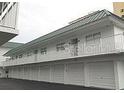 Exterior of building featuring garages and balconies at 3641 S Atlantic Ave # 212, Daytona Beach Shores, FL 32118