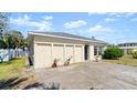 Exterior angle view of a quaint home with a well-maintained lawn and a paved driveway at 11 Briggs Dr, Ormond Beach, FL 32176
