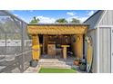 Backyard tiki bar perfect for outdoor entertaining. Surfboards and nautical art are decorating the bar at 111 Heron Dunes Dr, Ormond Beach, FL 32176