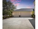 Spacious two-car garage with an extended driveway and tidy landscaping at 1432 Kinnard Cir, Ormond Beach, FL 32174