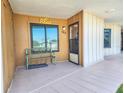 Charming condo entrance with bench seating and well-lit access, featuring a 'Relax' sign at 2600 Ocean Shore Blvd # 103, Ormond Beach, FL 32176