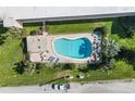 Aerial view of a private community pool featuring lounge chairs and beautiful landscaping at 2600 Ocean Shore Blvd # 103, Ormond Beach, FL 32176