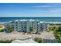 The exterior of the light blue condo building is captured from across the parking lot at 3390 Ocean Shore Blvd # 4020, Ormond Beach, FL 32176