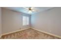 Bright bedroom featuring neutral walls, a ceiling fan, and a large window at 124 White Fawn Dr # 1240, Daytona Beach, FL 32114