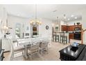 Bright dining area with white table set and seamless access to kitchen and patio at 1320 Hansberry Ln, Ormond Beach, FL 32174