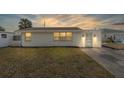 Charming single-story home with a well-lit front yard and a welcoming blue front door at 24 River Dr, Ormond Beach, FL 32176