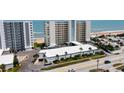 Exterior view of condo buildings with palm trees, showcasing prime beachfront property near the ocean at 1133 Ocean Shore Blvd # 303, Ormond Beach, FL 32176