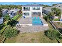 Aerial view of a backyard featuring a large pool with an in-ground spa and patio at 2244 S Halifax Dr, Daytona Beach, FL 32118