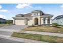 Attractive home with a three-car garage and beautifully landscaped front yard at 525 Mosaic Blvd, Daytona Beach, FL 32124