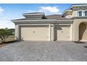 A spacious three-car garage featuring neutral doors and brick paved driveway at 525 Mosaic Blvd, Daytona Beach, FL 32124