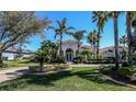 Charming single-story home boasts an immaculate lawn, mature landscaping, and a classic terracotta-tiled roof at 1317 Dovercourt Ln, Ormond Beach, FL 32174