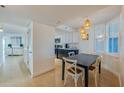 Bright dining area with hardwood floors, stylish lighting, and seating for four at 4545 S Atlantic Ave # 3206, Port Orange, FL 32127