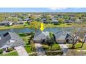 An aerial shot highlighting the home's location on the water and a well-maintained lawn at 6123 Jasmine Vine Dr, Port Orange, FL 32128