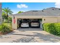 Spacious two car garage with two vehicles, storage and American flag displayed at 3428 Rexford Cir, Ormond Beach, FL 32174