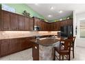 Beautiful kitchen with dark wood cabinets, granite countertops, and a center island at 1316 Harwick Ln, Ormond Beach, FL 32174