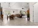 Open-concept living space with dining area, leather furniture, and sliding glass doors at 1316 Harwick Ln, Ormond Beach, FL 32174