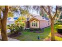 Charming home with manicured landscaping and mature trees creating a serene and inviting curb appeal at 3220 Galty Cir, Ormond Beach, FL 32174