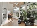 Bright sunroom featuring tile flooring, comfortable seating, and ample natural light from the surrounding windows at 3220 Galty Cir, Ormond Beach, FL 32174