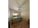 Cozy bedroom with vaulted ceiling, ceiling fan, and natural light at 105 Cattail Ct, Kissimmee, FL 34743