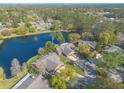 Expansive aerial view of the neighborhood, showcasing the tranquil pond and verdant surroundings at 206 Sage Brush Trl, Ormond Beach, FL 32174