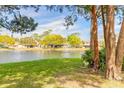 Scenic view of the lush lawn and pond in the backyard of the property at 206 Sage Brush Trl, Ormond Beach, FL 32174