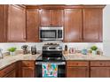 This kitchen boasts rich wood cabinetry, granite countertops, and stainless steel appliances at 251 Island Breeze Ave, Daytona Beach, FL 32124