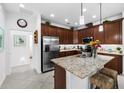 Modern eat-in kitchen featuring a center island with bar seating, granite countertops and stainless appliances at 251 Island Breeze Ave, Daytona Beach, FL 32124