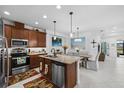 Beautiful eat-in kitchen with an island, granite countertops, stainless steel appliances, and modern lighting at 251 Island Breeze Ave, Daytona Beach, FL 32124