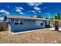 Side view of a charming single-story home with a well-maintained lawn and walkway at 30 Azalea Dr, Ormond Beach, FL 32176