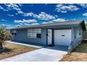 Charming single-story home with a garage, front door, and well-maintained walkway at 30 Azalea Dr, Ormond Beach, FL 32176