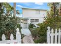 Two story home featuring a picket fence, sidewalk, and well maintained front yard plants and bushes at 322 Garden St, Daytona Beach, FL 32114
