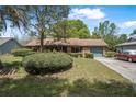 Charming single-story brick home featuring a well-maintained front yard and attached garage at 3385 Ne 44Th Pl, Ocala, FL 34479