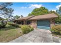 Traditional brick home with an attached garage and neatly trimmed landscaping at 3385 Ne 44Th Pl, Ocala, FL 34479