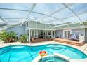 Relaxing screened-in pool area with ample deck space for outdoor entertaining and a sparkling blue swimming pool at 6172 Knotty Pine Ct, Port Orange, FL 32127