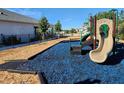 Community playground with a slide and soft blue and brown ground cover for comfort and safety at 1010 Megano Blvd, Deland, FL 32724