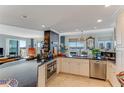 Bright and airy kitchen featuring stainless appliances, granite counters, and dining area with chandelier at 925 N Halifax Ave # 1105, Daytona Beach, FL 32118