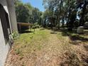 Expansive backyard featuring a covered wooden structure amidst a lush, tree-filled landscape at 230 Katrina St # 230, De Leon Springs, FL 32130