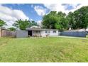Charming single-story home featuring a well-manicured lawn, updated exterior paint, and mature trees in the yard at 220 Woodmere Blvd, Sanford, FL 32773