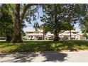 The property features multiple residences with covered parking and mature trees at 1 Tomoka Oaks Blvd # 102, Ormond Beach, FL 32174
